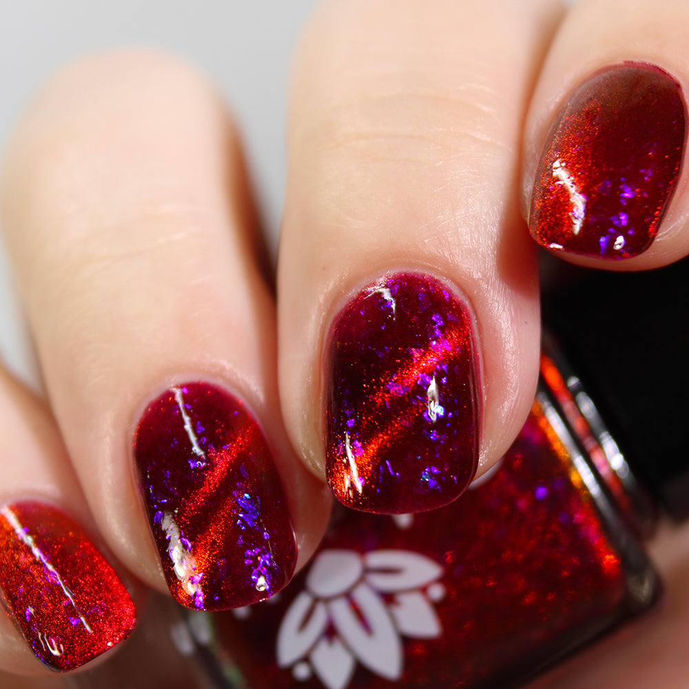 Hard To Ignore - A red magnetic nail polish with blue flakes