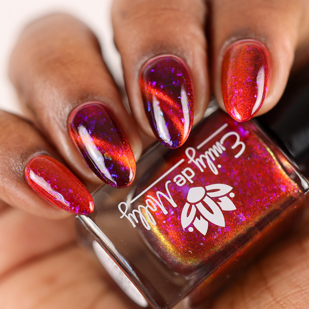 Hard To Ignore - A red magnetic nail polish with blue flakes