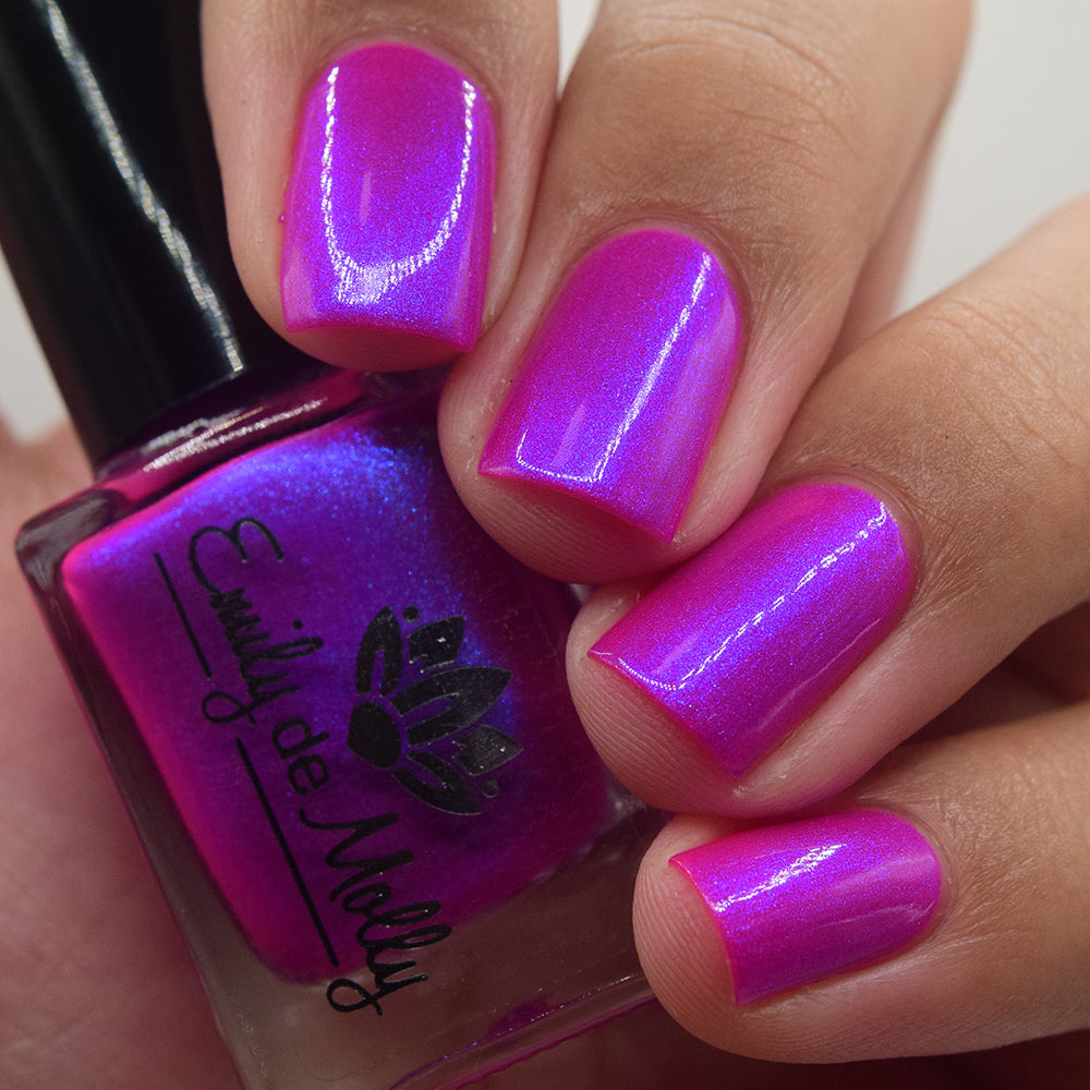 Done It Again - A bright neon pink nail polish with blue shimmer